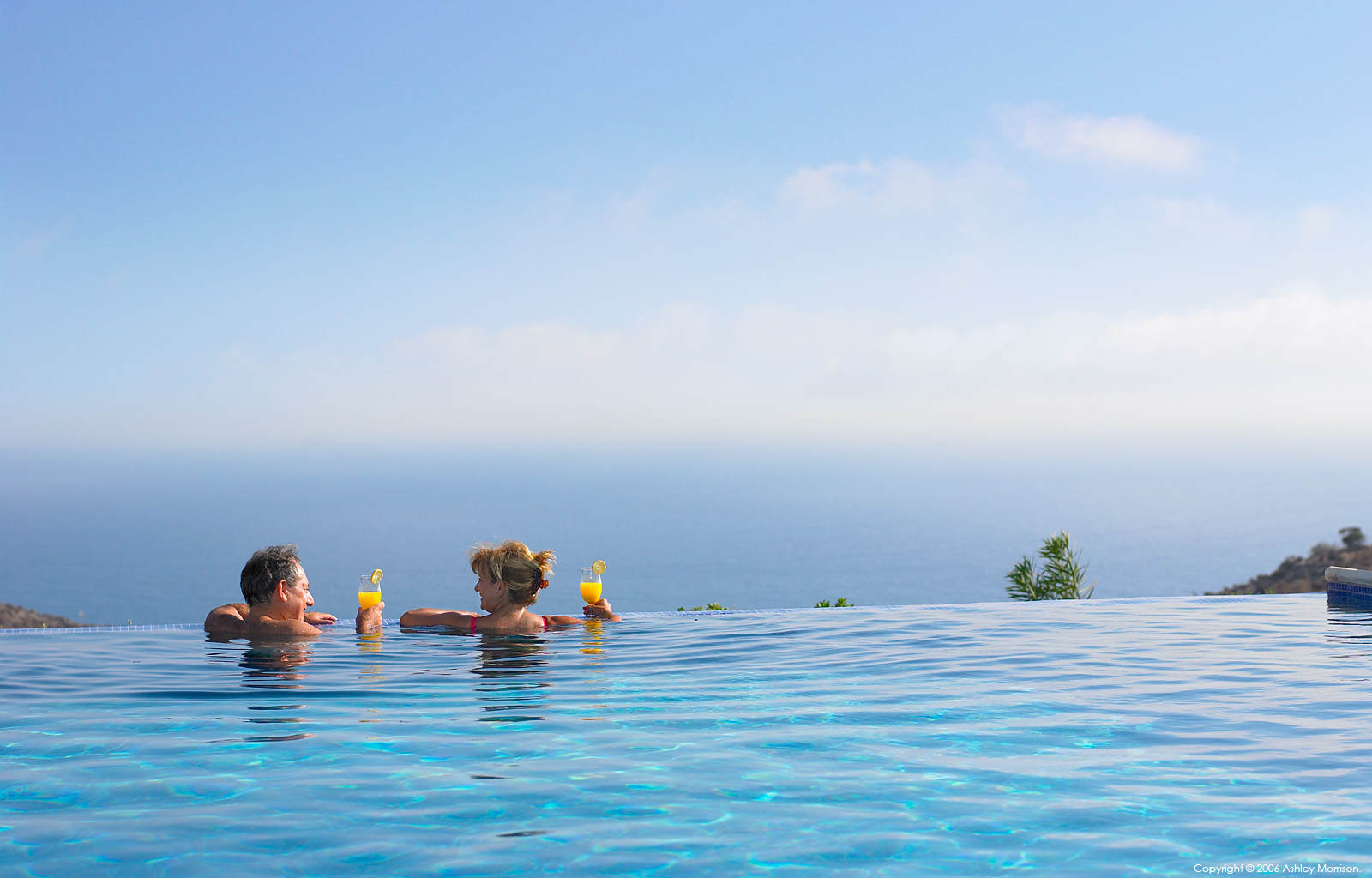 Rose and Julius Cohen in the infinity swimming pool outside their villa at the Aphrodite Hills complex in Cyprus.